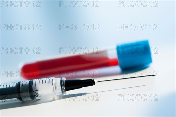 Studio shot of blood sample and syringe.