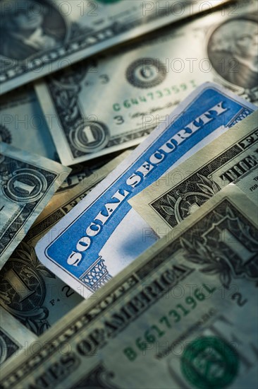 Studio shot of social security card and banknotes.