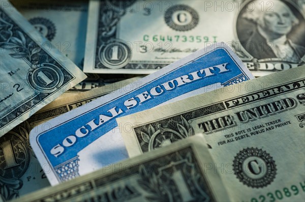 Studio shot of social security card and banknotes.