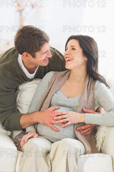 Man touching pregnant woman's belly.