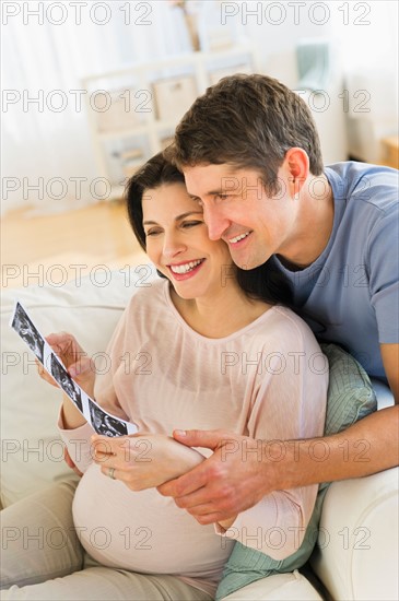 Couple looking at ultrasound photo.