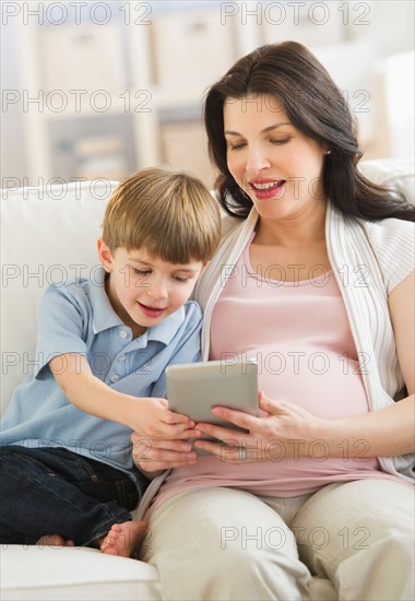 Mother and son (4-5) using tablet pc.