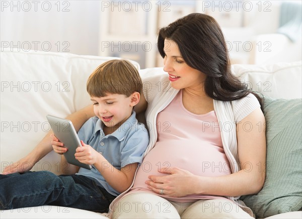 Mother and son (4-5) using tablet pc.