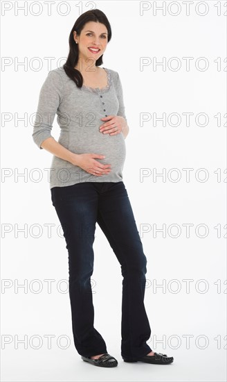 Studio portrait of pregnant woman.