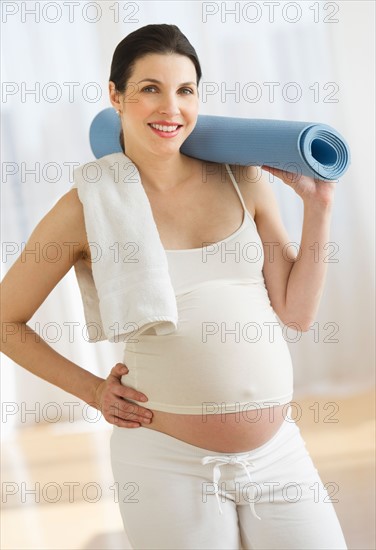 Portrait of pregnant woman exercising.