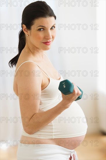 Portrait of pregnant woman exercising.