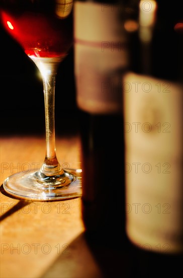 Studio shot of wine glass and bottles.