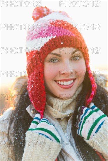 Portrait of young woman wearing knit hat.