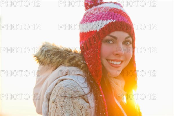 Portrait of young woman wearing knit hat.
