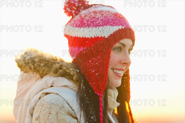 Portrait of young woman wearing knit hat.