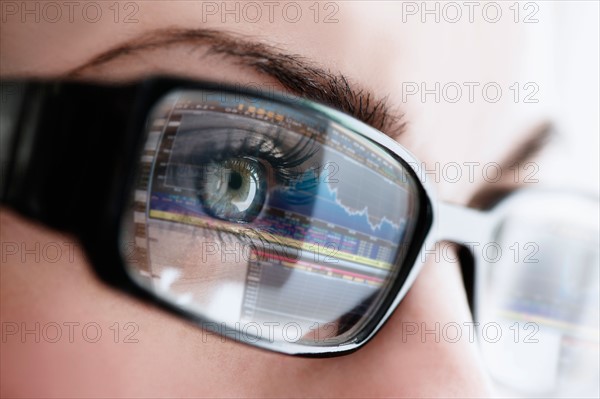 Studio close-up of woman wearing eyeglasses.