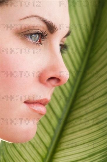 Studio shot of woman and leaf.