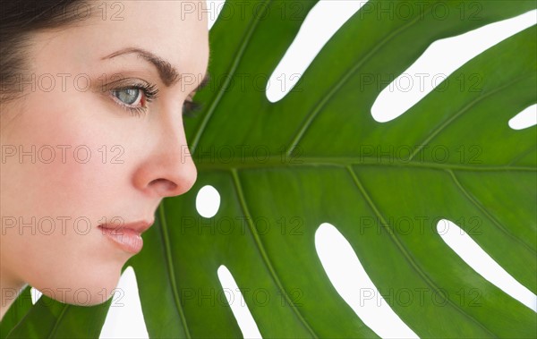 Studio shot of woman and leaf.