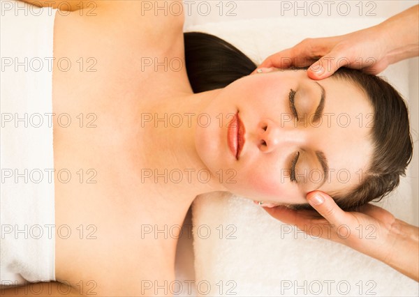 Woman receiving face massage.