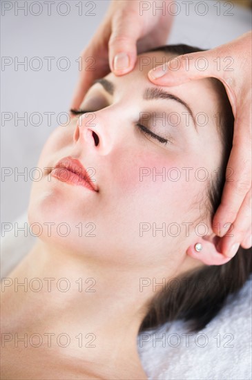 Woman receiving face massage.