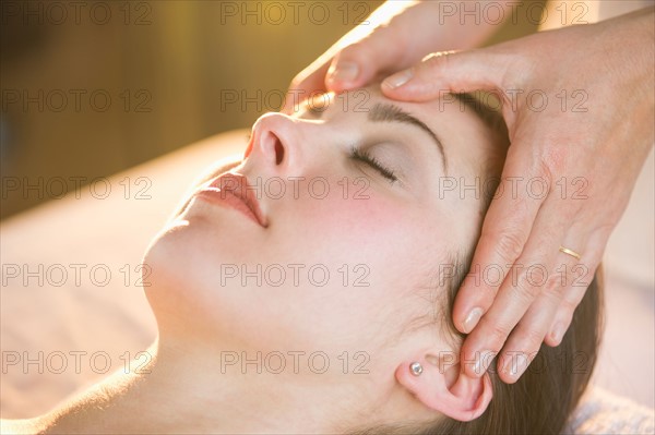 Woman receiving face massage.
