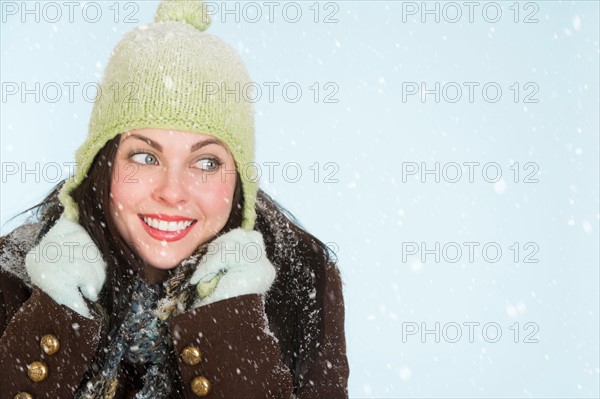 Studio portrait of woman in winter clothing.