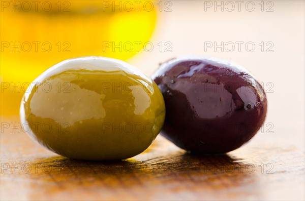 Close-up of black and green olives, studio shot.