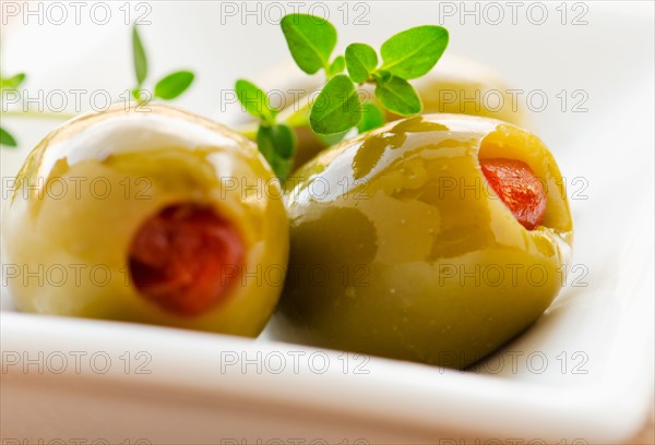 Close-up of green olives stuffed with pimento, studio shot.