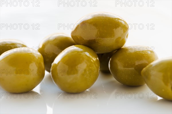 Close-up of green olives, studio shot.