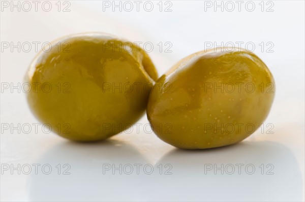 Close-up of green olives, studio shot.