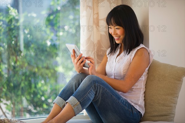 Smiling mid adult woman using digital tablet.