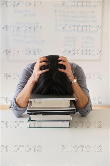 Frustrated woman in front of board with equations.