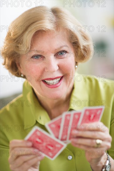 Senior woman playing cards.