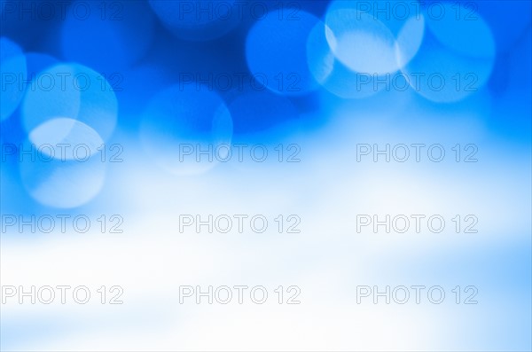 Glowing light on blue background, studio shot.