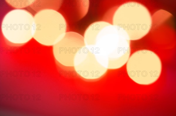 Glowing light on red background, studio shot.