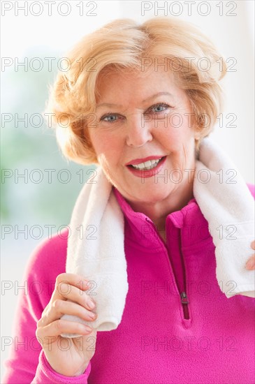 Portrait of smiling senior woman with towel.