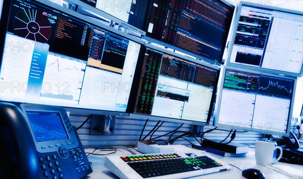 Monitors above trading desk.