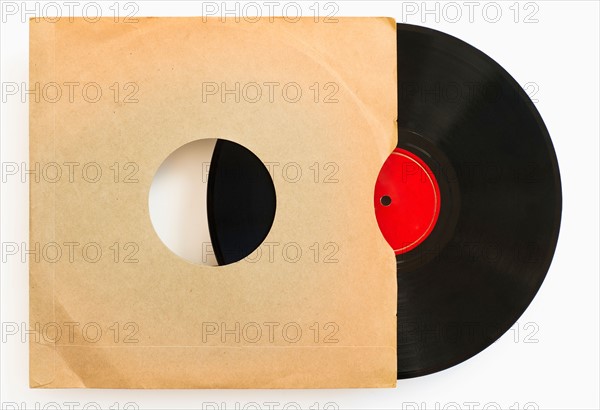 Vinyl record in envelope on white background, studio shot.