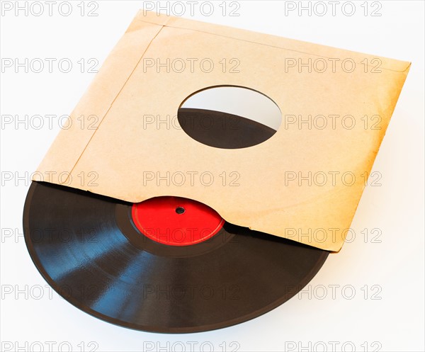 Vinyl record in envelope on white background, studio shot.