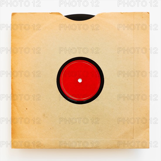 Vinyl record in envelope on white background, studio shot.