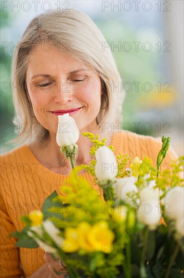 Portrait of senior woman with bouquet celebrating Mother's Day.
