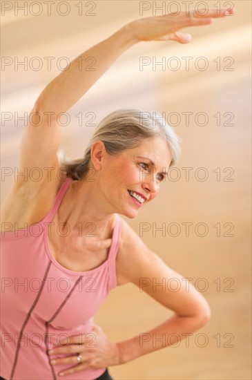 Portrait of senior woman exercising in gym.