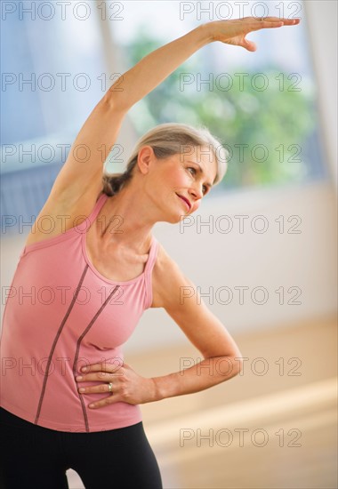 Portrait of senior woman exercising in gym.