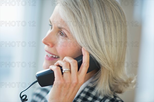 Portrait of senior businesswoman talking on phone.