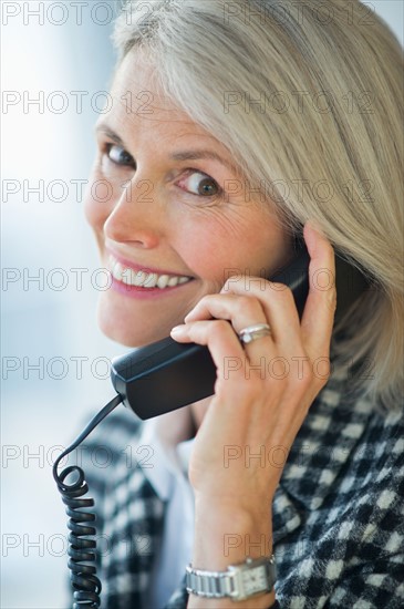 Portrait of senior businesswoman talking on phone.