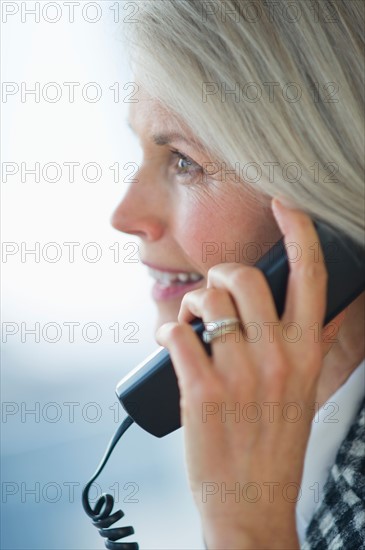 Portrait of senior businesswoman talking on phone.