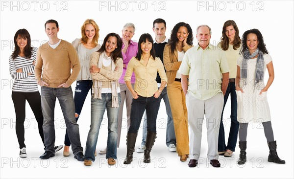 Studio portrait of large group of people standing arm in arm.