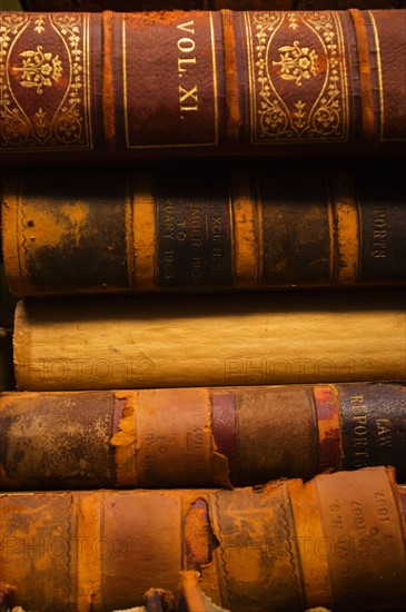 Close up of antique books in leather covers, studio shot.