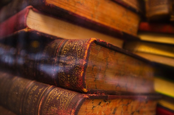 Close up of antique books in leather covers, studio shot.