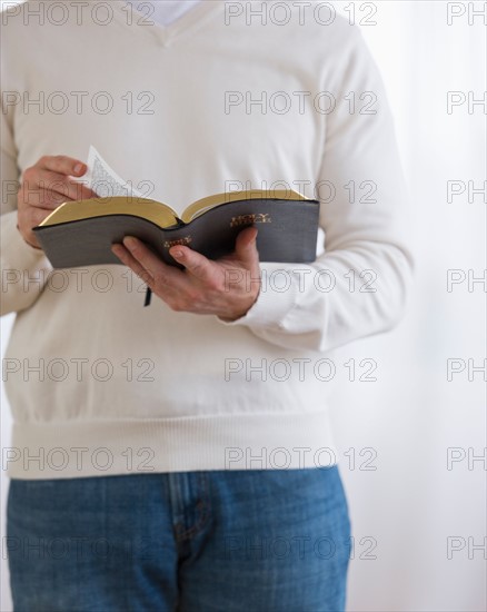 Man holding bible.