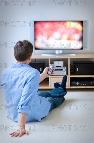 Man watching tv in living room.