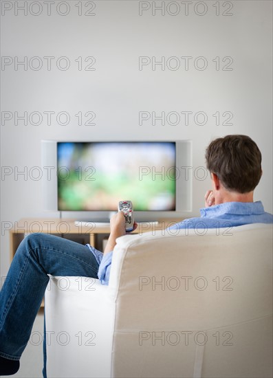 Man watching tv in living room.