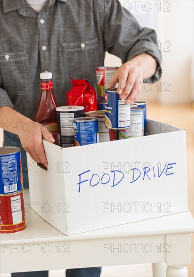 Man packing food for donation.