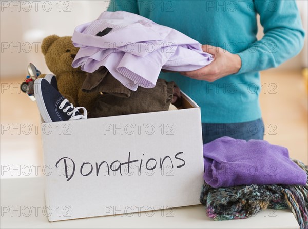 Man packing clothes for donation.
