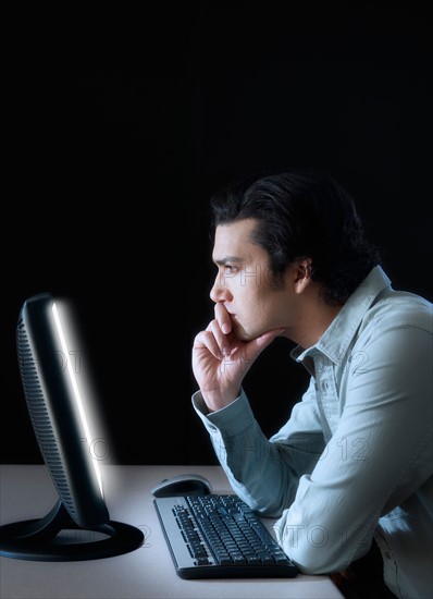 Man working with computer, studio shot.